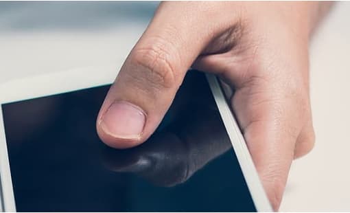 Hand holding mobile phone.