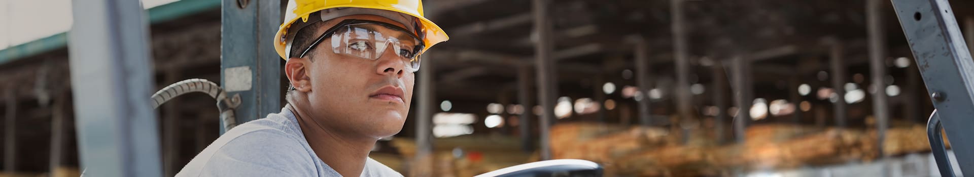 Occupational Health: Person wearing a hardhat and safety glasses