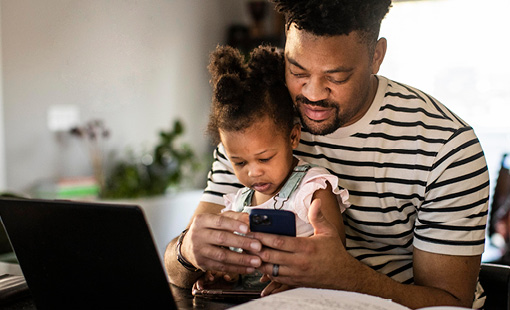 Patient utilizing self-scheduling while a child sits on their lap