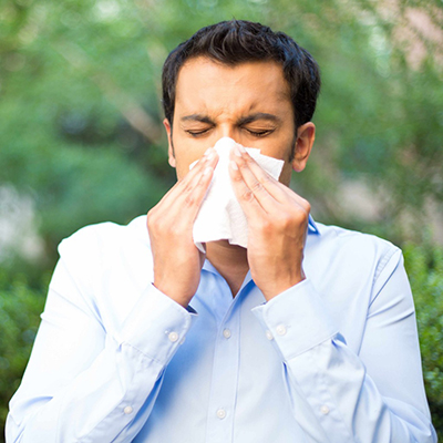manblowingnoseoutside