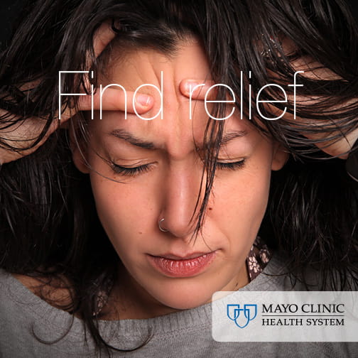 Person with migraine with hands on temples