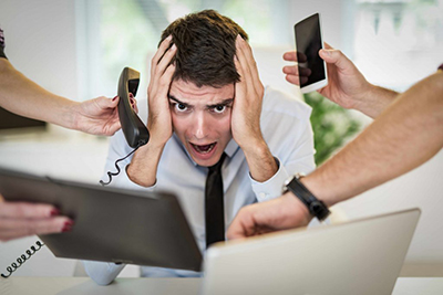 stressedmanwithphoneandcomputer