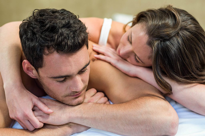 couple-in-bed-with-woman-consoling-man