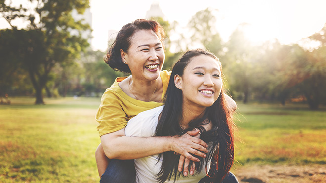 Two happy young women piggybacking
