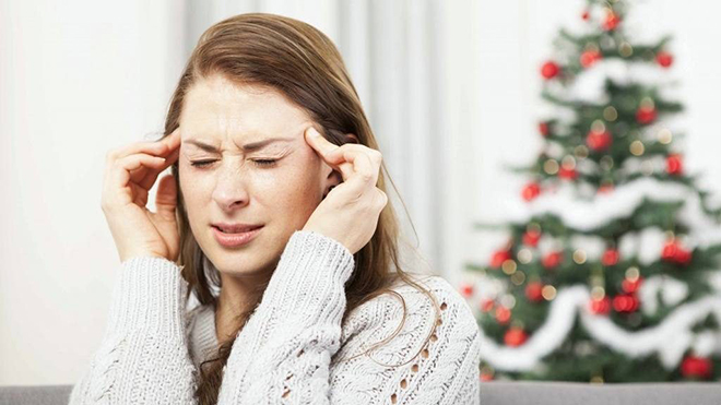woman-stressed-with-a-headache-at-the-Christmas-holidays