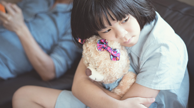 Young child hugging a teddy bear