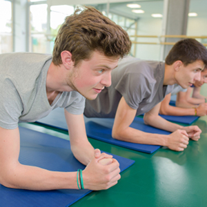 Young male athletes doing yoga