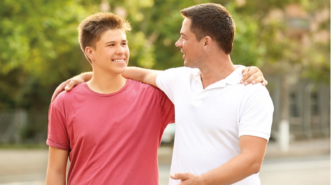 Dad and son arm in arm