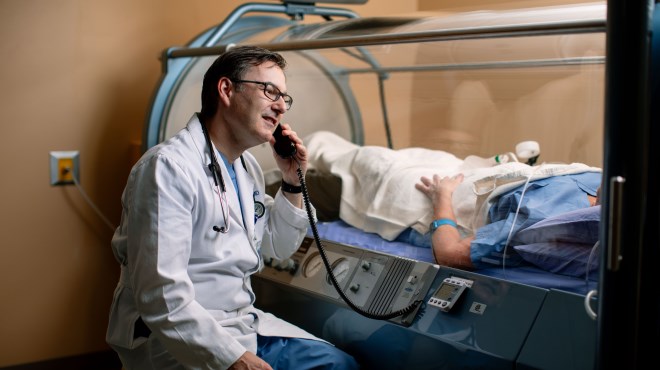 Doctor talking to patient in hyperbaric oxygen therapy chamber
