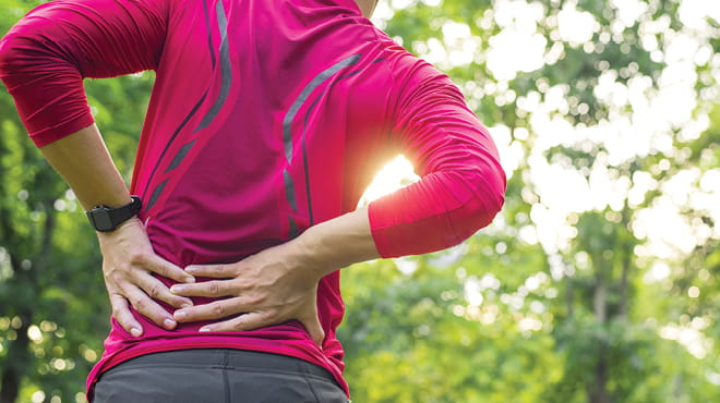 Hands touching back due to pain