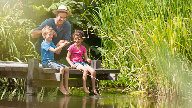 Man and kids sitting on dock