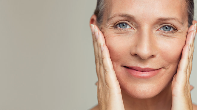 Middle-age woman hands on face
