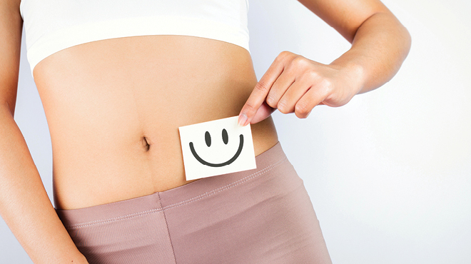 Smiley face by female stomach