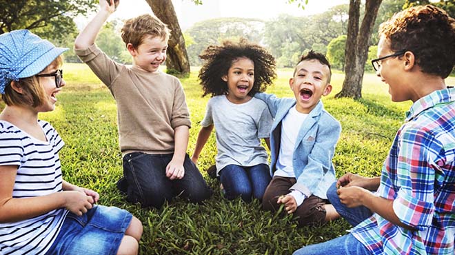 Children sitting in circle laughing