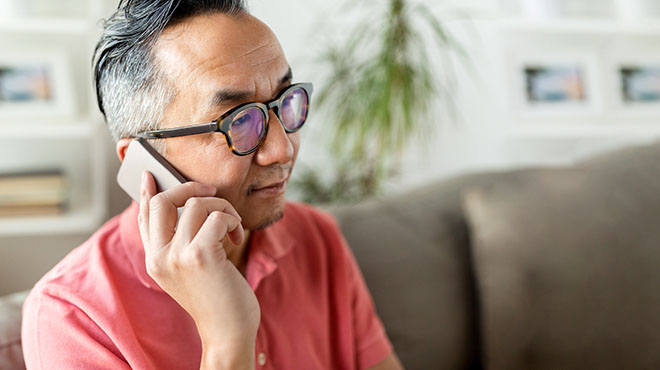 Man with glasses on cellphone
