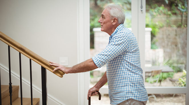 Older man looking up stairs