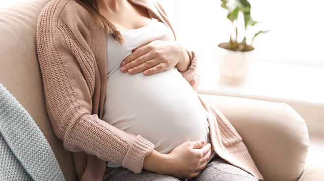 Pregnant woman holding baby bump