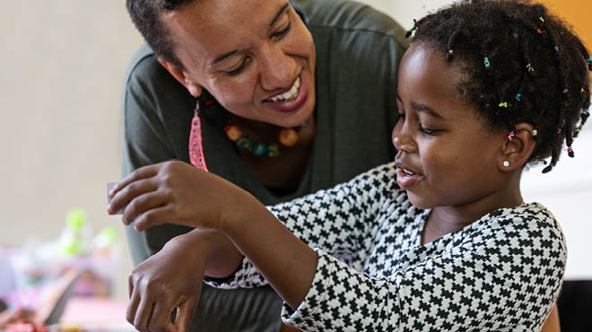 Adult leaning down to child