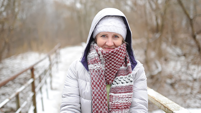 Woman bundled up in winter clothes standing outdoors