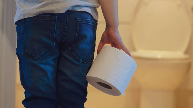 Child holding toilet paper roll