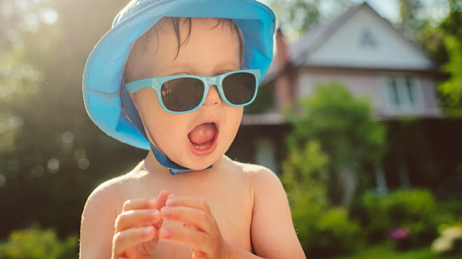 Child wearing sunglasses and bucket hat