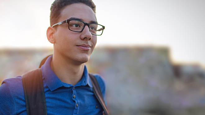 College student wearing glasses and backpack