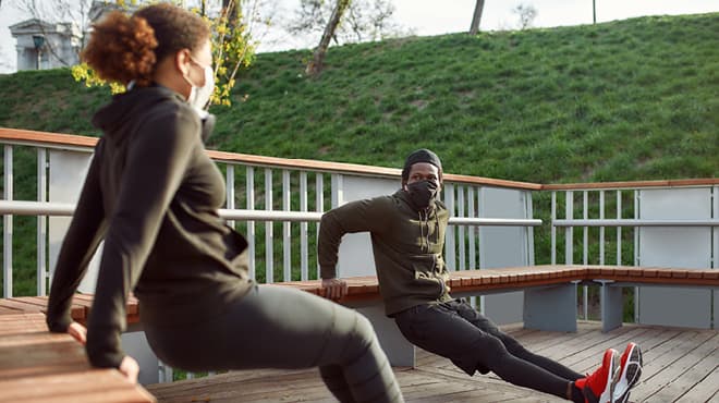 Couple wearing masks while working out
