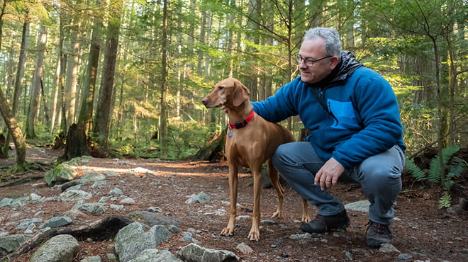 Dog and owner in the woods