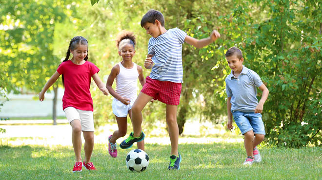 Kids kicking soccer ball