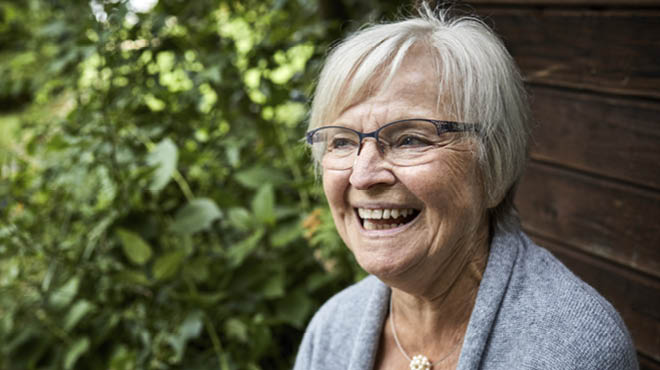 Mature, gray-haired person with glasses