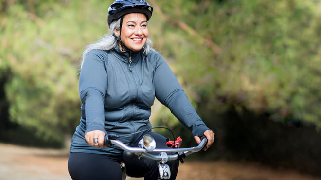 Riding bicycle wearing helmet