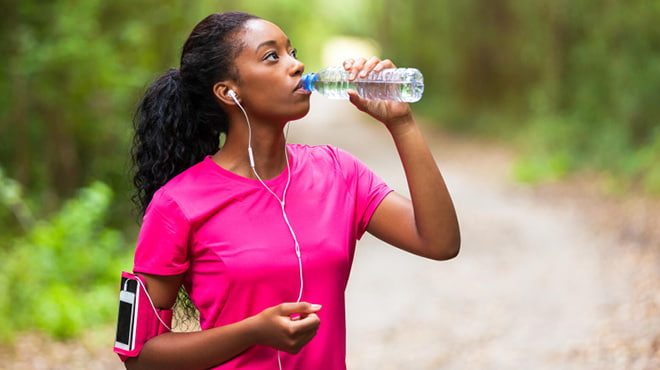 Runner drinking bottled water