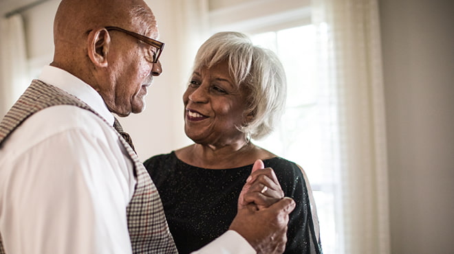 Senior couple dancing and holding hands