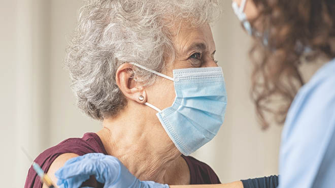 Senior woman receiving vaccination