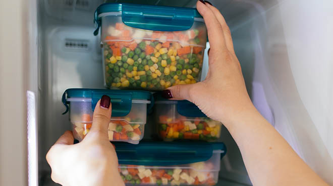 Vegetables in containers in freezer