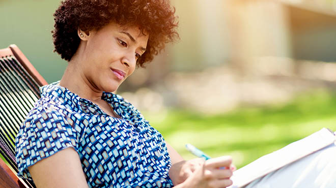 Writing while seated outdoors