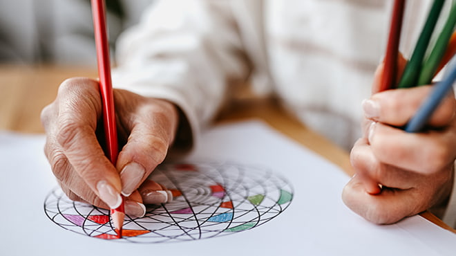 Adult using colored pencils