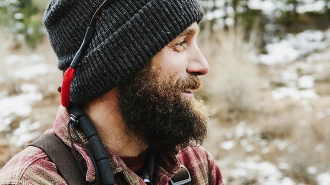 Bearded person wearing stocking cap