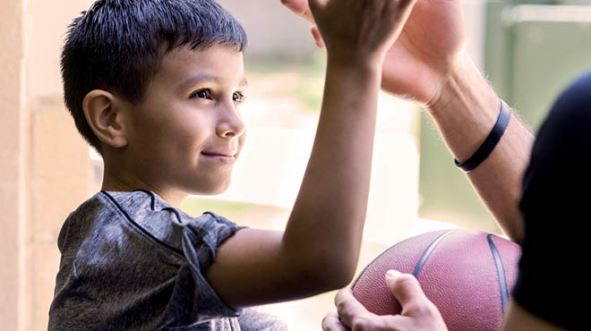 Child and parent playing hand games