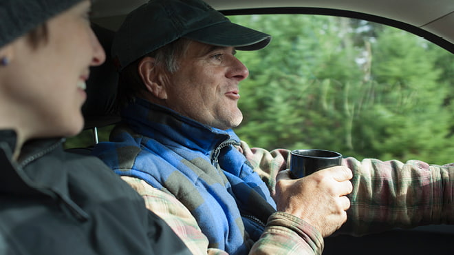 Car driver with cup in hand