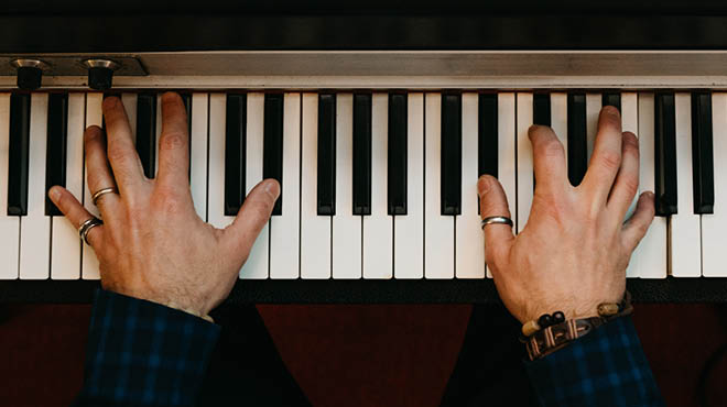 Fingers on piano keys