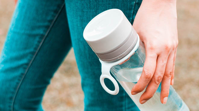 Hand holding water bottle