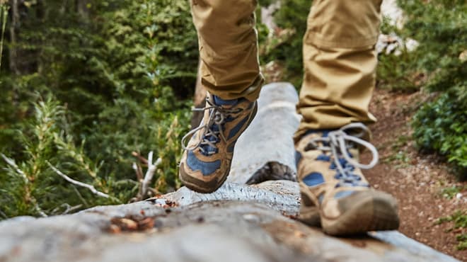 Hiking boots on log