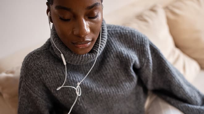 Listening with earbuds grey sweater