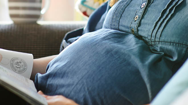 Pregnant woman reading a book