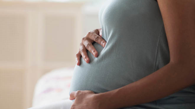 Pregnant woman holding belly