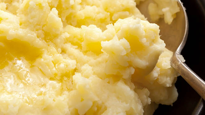 Spoon in mashed potatoes