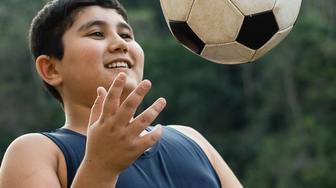 Teen tossing soccer ball