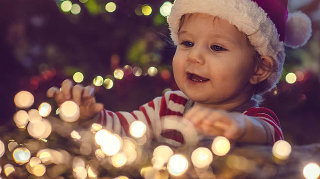 Toddler by holiday lights