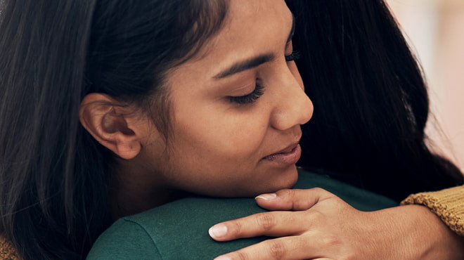 Two people hugging close-up